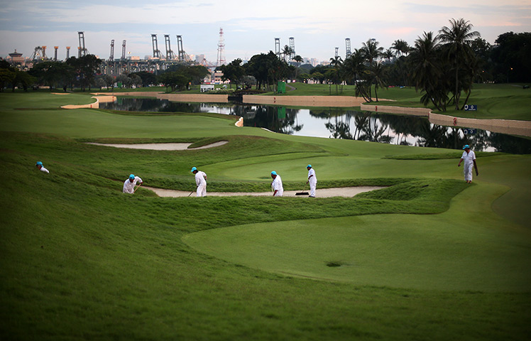 Singapore: Workers prepare the golf course at the Singapore Open