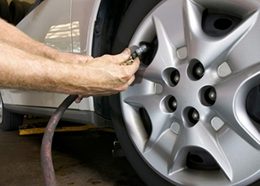 mechanic-inflating-car-tire